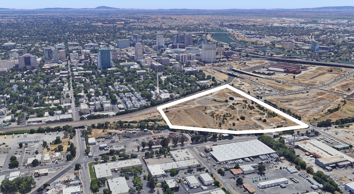 Sacramento Railyards Stadium property current condition, image via Google Satellite, with property line approximately outlined by SFYIMBY