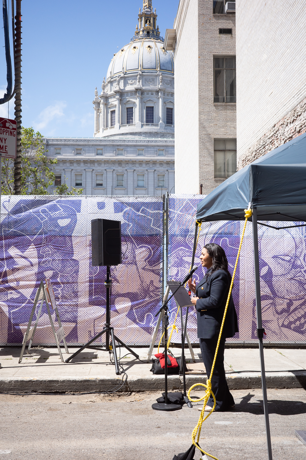 Mayor London Breed speaking at the Kelsey groundbreaking with City Hall in the background, image by author